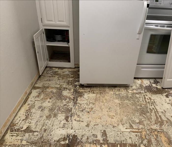 Floor in kitchen has been torn up as a result of severe water damage